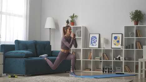 woman-is-squatting-in-living-room-of-modern-apartment-training-and-doing-physical-exercise-for-health-and-beauty-full-lenght-shot-in-house
